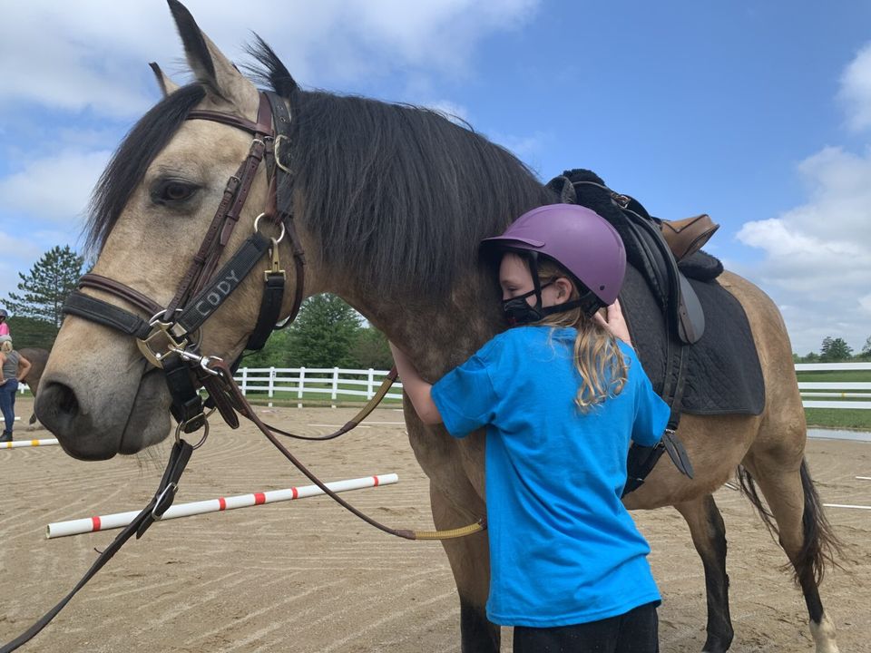 Student hugging Cody the horse