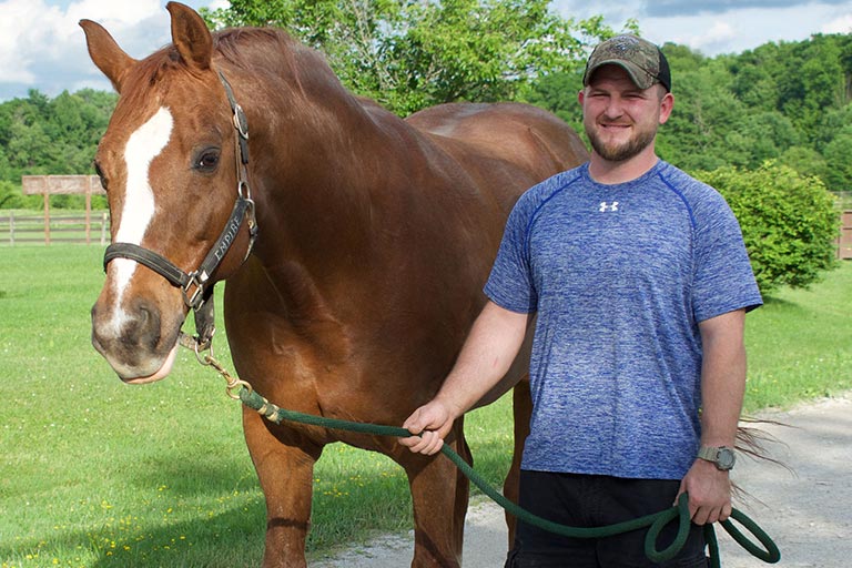 Veteran leading a horse