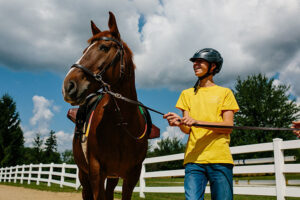 Wayne holding a horse's lead