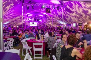 Chefs Unbridled 2016, guests sitting in a large party tent with a lit ceiling, photo by Frank Gwirtz