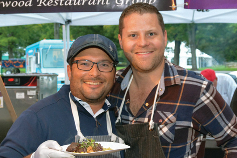 Chefs with a plate of food at Chefs Unbridled